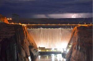A high desert thunderstorm lights up the sky behind Glen Canyon Dam -- Photo USBR