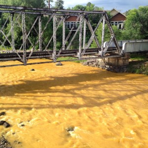 The Animas flows orange through Durango on Aug. 7, 2015, two days after the Gold King Mine spill. (Photo via www.terraprojectdiaries.com)