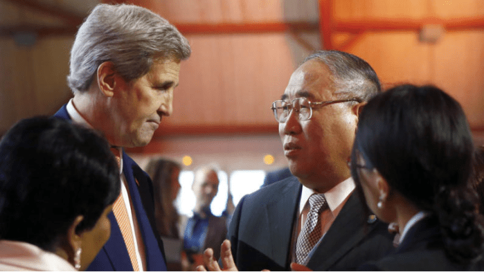 U.S. Secretary of State John F. Kerry, left, talks with China's special representative on climate change Xie Zhenhua prior to the opening of the COP21 conference in Le Bourget, France on Saturday. (Francois Mori / AP)