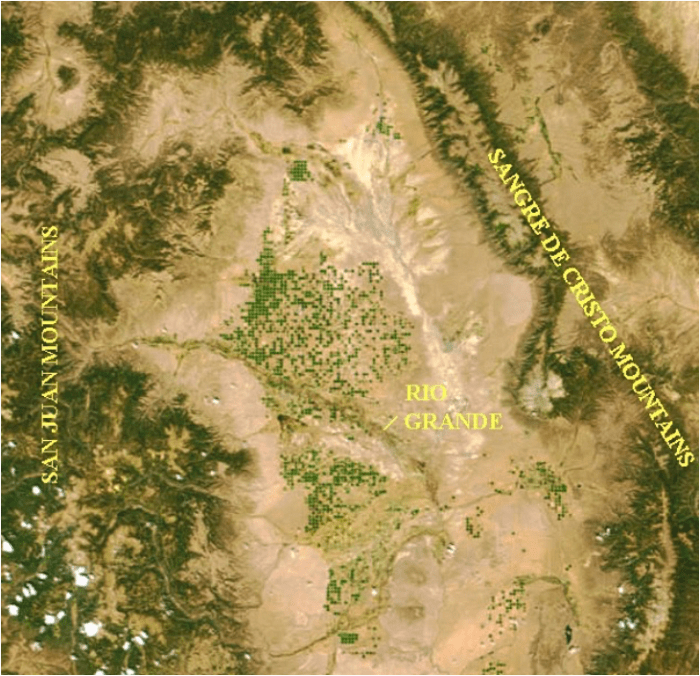 The Upper Rio Grande/Rio Arriba Watershed  (highlighting location of center-pivot sprinkler circles)  Note: Green dots are center-pivot farm and ranch operations, most with junior groundwater withdrawal rights and subject to court-ordered mandates designed to mitigate damages to farmers with senior surface rights (including acequias) and to augment deliveries to the Rio Grande Interstate Compact.  Source: NASA/MODIS files at: http://www.oneonta.edu/faculty/baumanpr/geosat2/Dry_Land_Water/Dry_Land_Water.htm