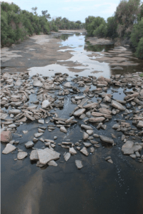 The South Platte River typically all but vanishes as it passes through Denver’s industrial neighborhood north of downtown, downstream of the Burlington Ditch diversion, near the Cherokee power plant. Photo/Allen Best