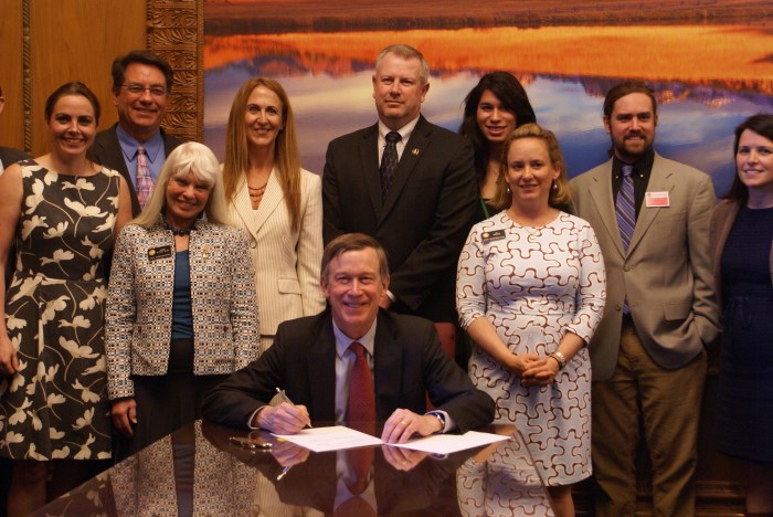 Gov. John Hickenlooper signs House Bill 16-1109 on April 21, 2016, with state Senators Kerry Donovan and Jerry Sonnenberg, state Reps. Diane Mitsch Bush, Jon Becker, and KC Becker; and Kristin Moseley, Theresa Conley, and legislative aides.