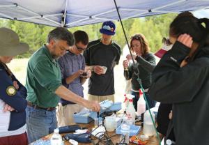 Chemistry professor James Ranville (second from left) leads students in analyzing water samples from streams near mining operations during the Department of Chemistry’s summer field session. (Credit: Mark Ramirez)