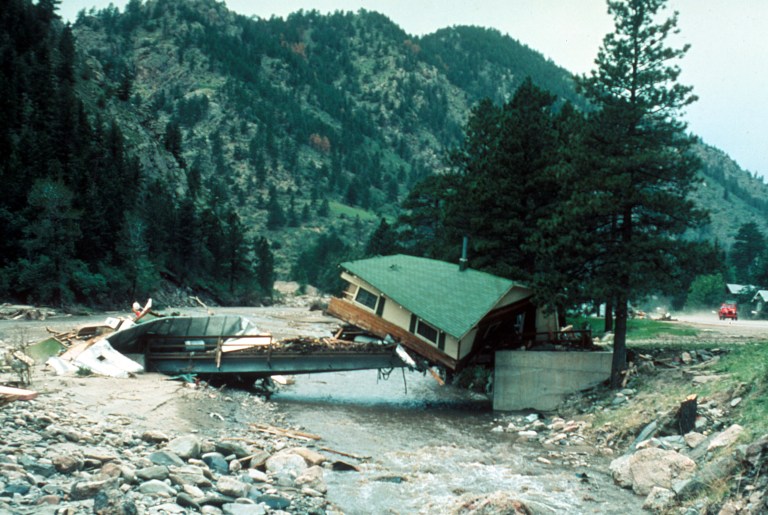 Big Thompson Flood, Colorado. Cabin lodged on a private bridge just below Drake, looking upstream. Photo by W. R. Hansen, August 13, 1976. Photo via the USGS.