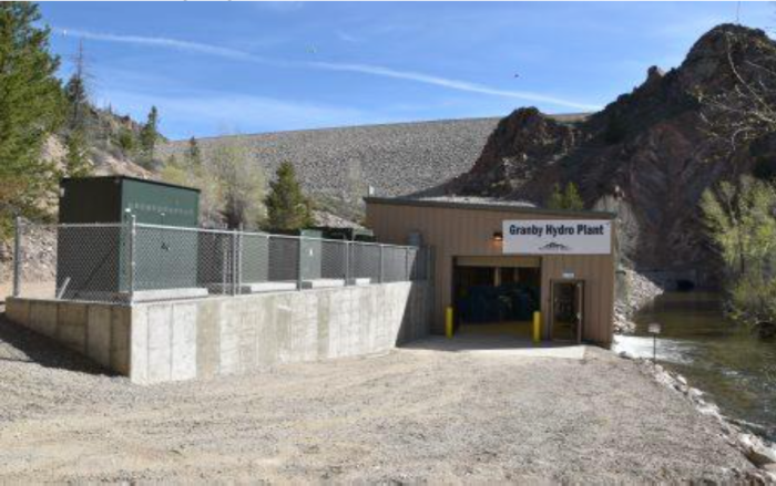 View of the Granby Hydropower Plant with Granby Dam in the background. Photo via Northern Water.