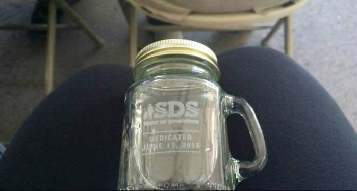 All that was left at the end of 75 minutes of speeches was to have a sip of SDS water. Photo via the Colorado Springs Independent.