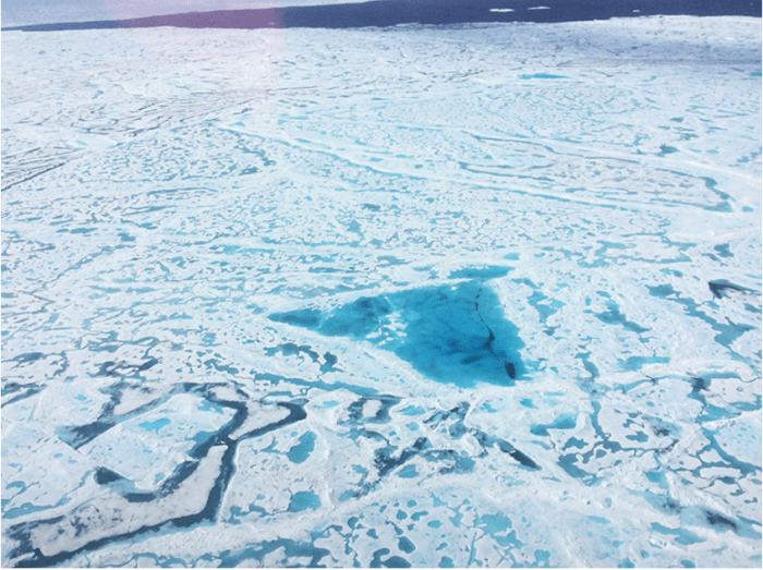 A large pool of melt water over sea ice, as seen from an Operation IceBridge flight over the Beaufort Sea on July 14, 2016. During this summer campaign, IceBridge will map the extent, frequency and depth of melt ponds like these to help scientists forecast the Arctic sea ice yearly minimum extent in September. Credit: NASA/Operation IceBridge.