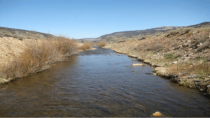 While adjoining streets and buildings were quickly removed, the Eagle River today flows in a ditch created at Camp Hale in 1942. Photo credit Allen Best The Mountain Town News.