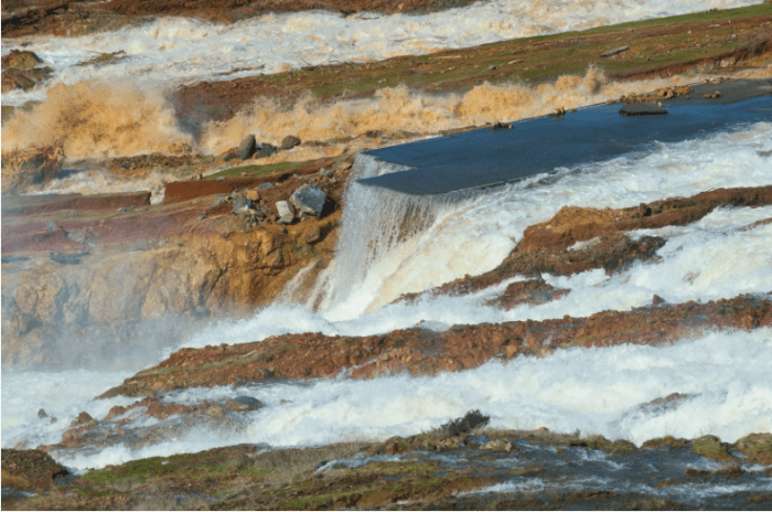 Water from the Oroville Dam auxiliary spillway has eroded the roadway just below the spillway. Photo courtesty of Kelly M. Grow/ California Department of Water Resources.