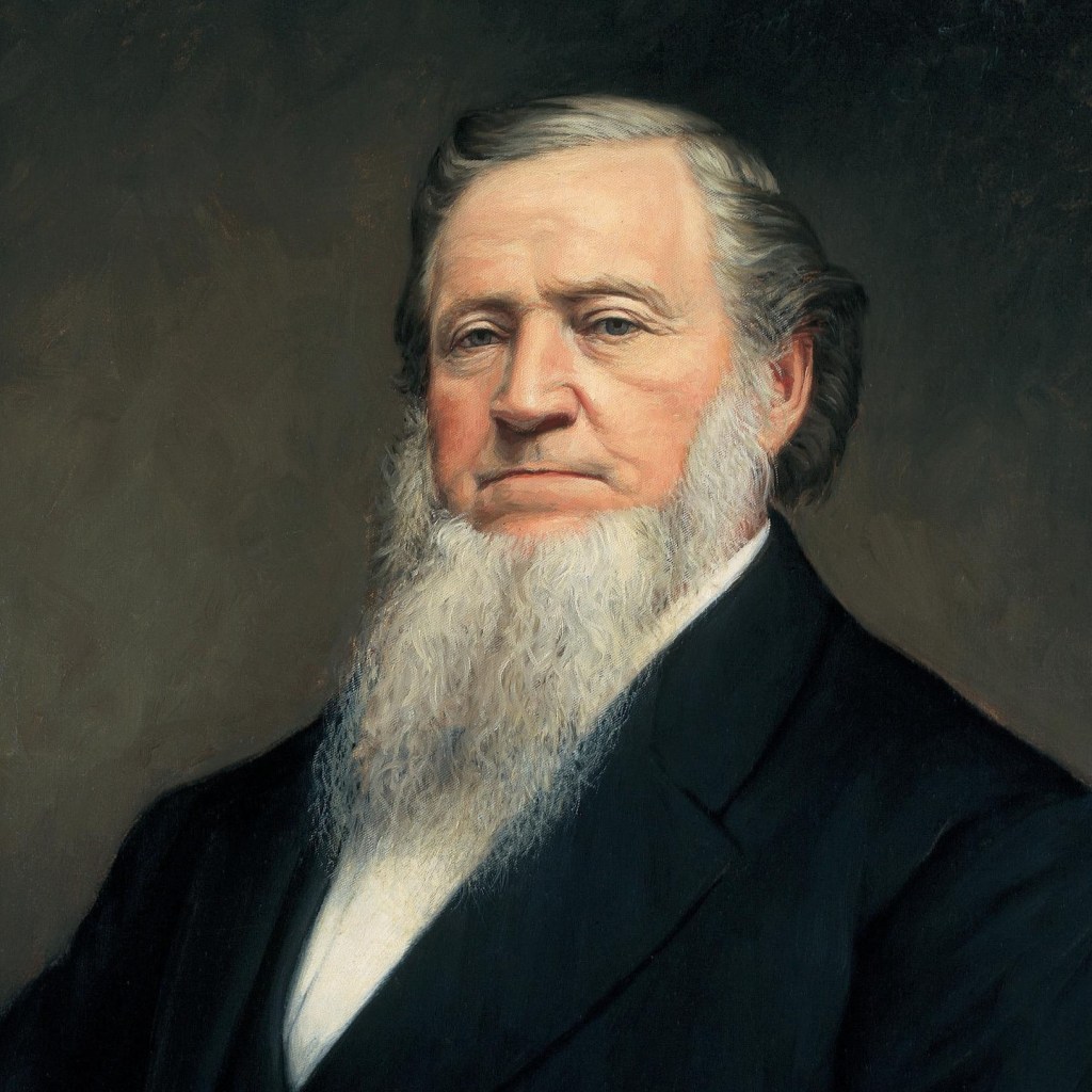 A portrait of a man with a prominent beard and historical attire, featuring a solemn expression against a dark background.